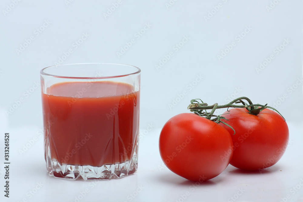 a glass of tomato juice and tomatoes isolated on white backgrond a glass of tomato juice and tomatoes isolated on white backgrond