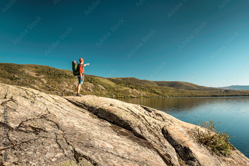 Man hiking near a beautiful lake