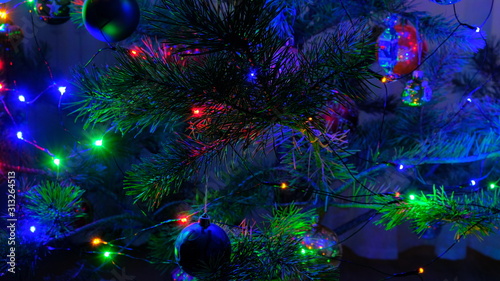 Christmas tree with illumination decorated with balls and other Christmas tree decorations