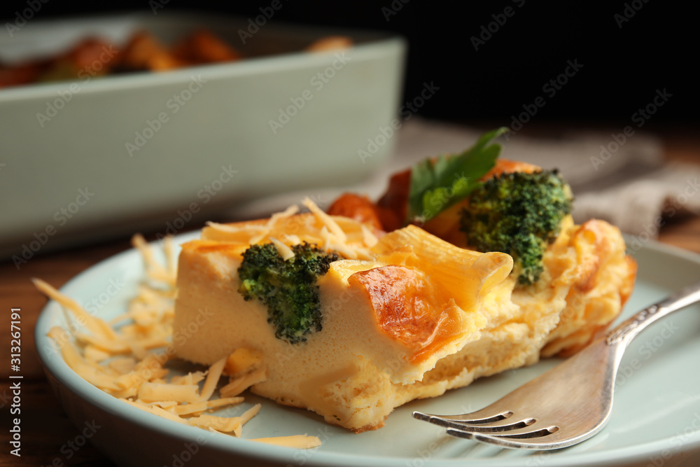Tasty broccoli casserole with cheese on plate, closeup
