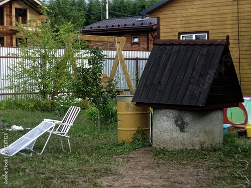 folding chair in the yard of a rural house in summer, Russia.