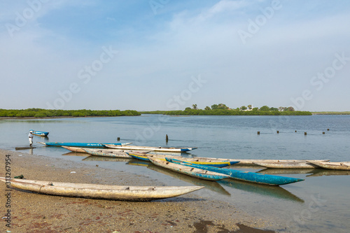 Fishers and small long boats. Fadiauth Island. Senegal. West Africa.