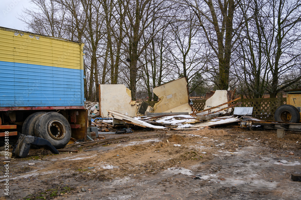 The concept of trash environmental disaster. Photo of a landfill on a street in a city on a cloudy day.