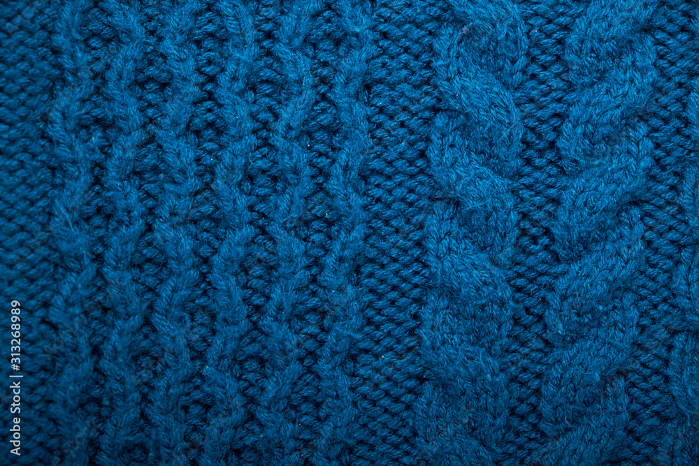 Knitted background. Knitted texture. A sample of knitting from wool. Knitting Pattern.