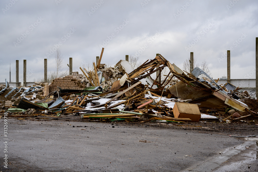The concept of trash environmental disaster. Photo of a landfill on a street in a city on a cloudy day. The concept of trash environmental disaster. Photo of a landfill on a street in a city on a cloudy day.