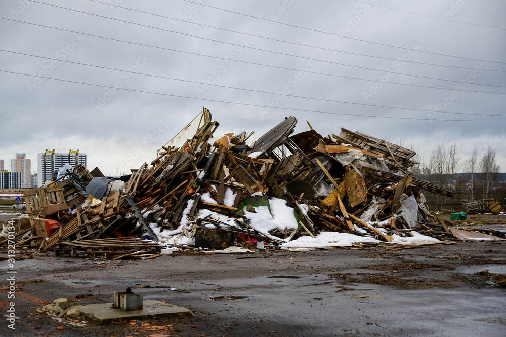 The concept of trash environmental disaster. Photo of a landfill on a street in a city on a cloudy day. The concept of trash environmental disaster. Photo of a landfill on a street in a city on a cloudy day.