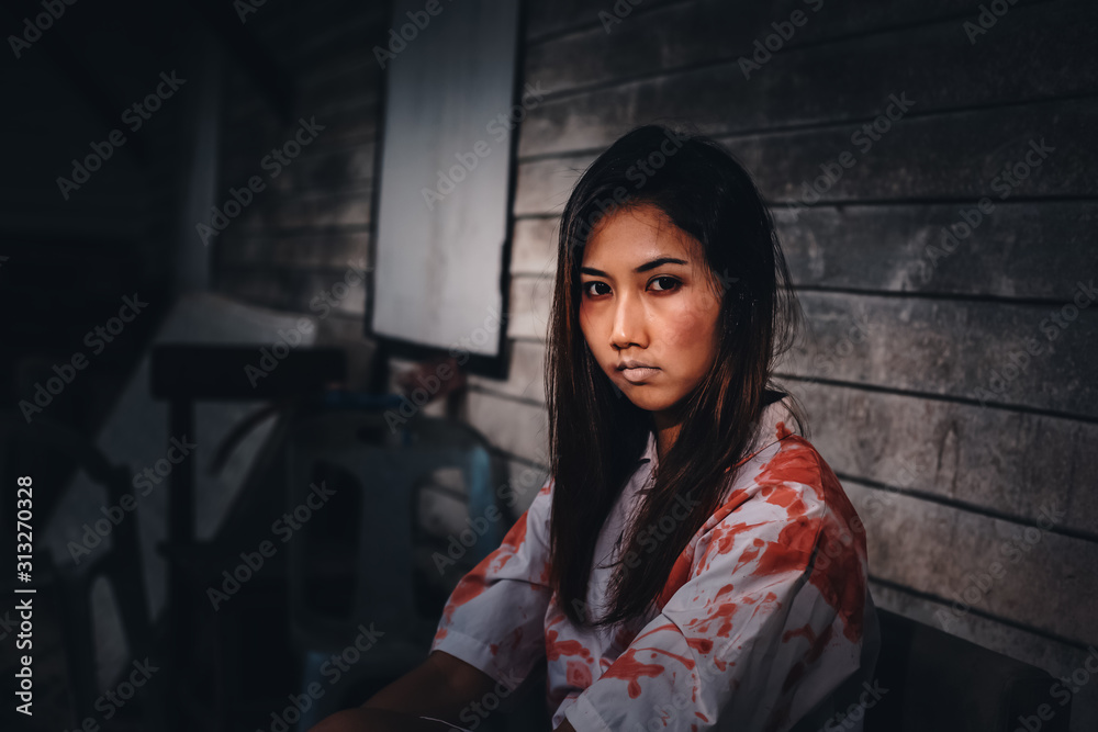 A women sitting at abandonat with Halloween concept. A women sitting at abandonat with Halloween concept.