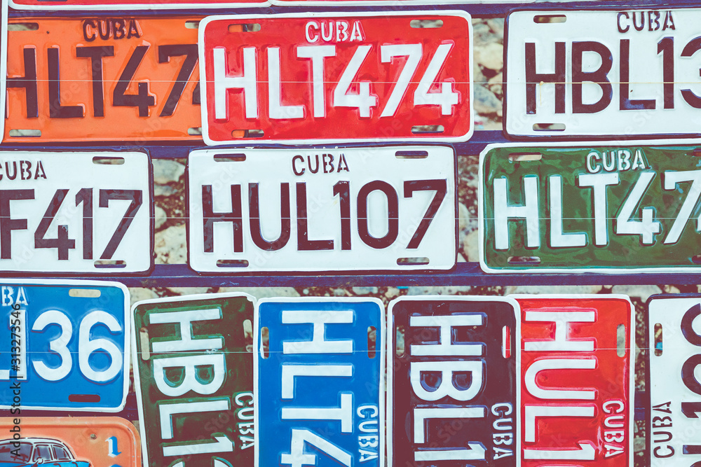 HAVANA, CUBA - DECEMBER 18, 2019:  Traditional handcrafted vehicle registration plates like souvenirs for sale in La Havana, Cuba.