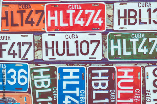 HAVANA, CUBA - DECEMBER 18, 2019: Traditional handcrafted vehicle registration plates like souvenirs for sale in La Havana, Cuba.