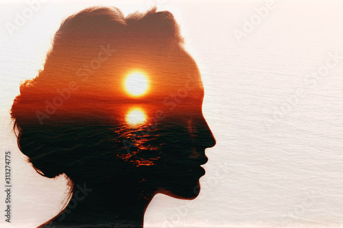 Conceptual double exposure. Sunrise in the woman head. photo