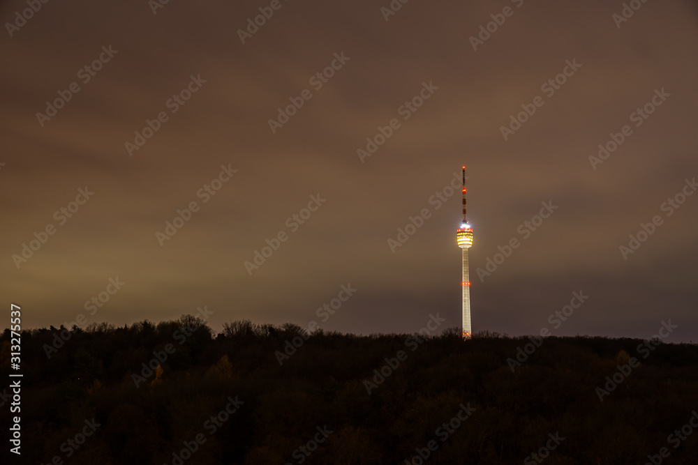 Germany, Famous illuminated tv tower building in endless forest nature landscape of city stuttgart by night