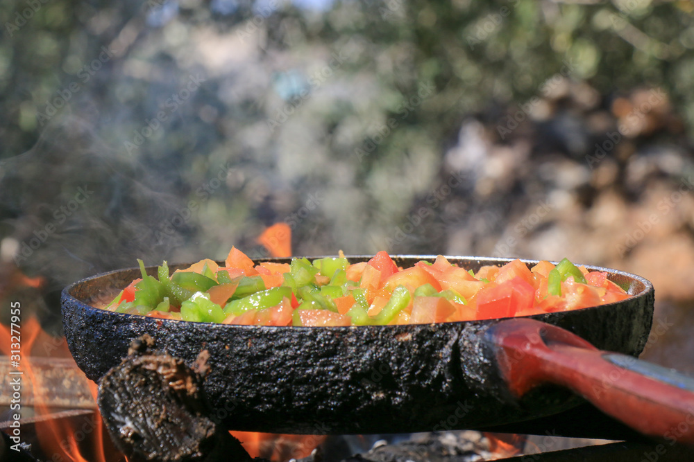Frying tomatoes in nature