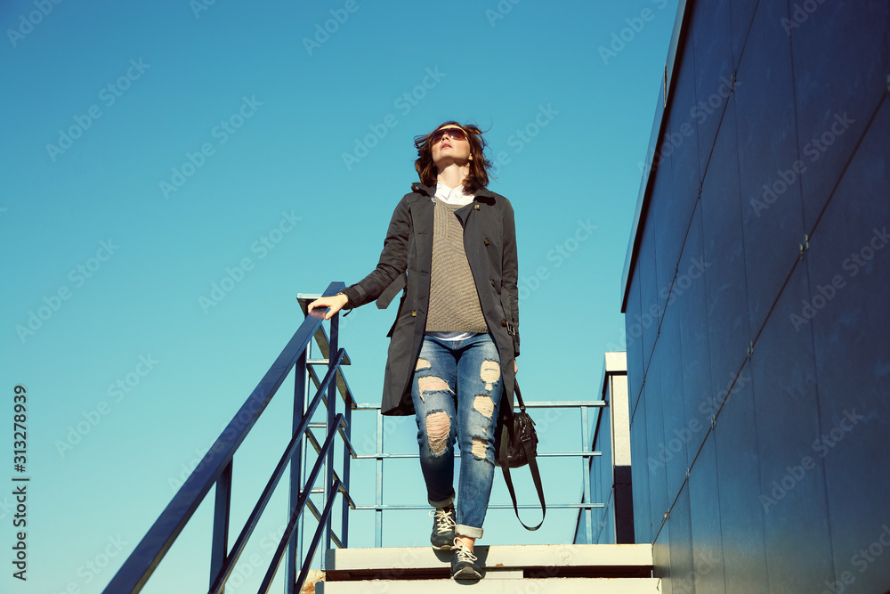 outdoor portrait of a stylish woman with a bag. businesswoman in a street.