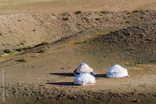 Three yurts of nomadic pastoralists. Chui steppe, Kyzyl-Chin valley. Autumn in the Altai Mountains photo