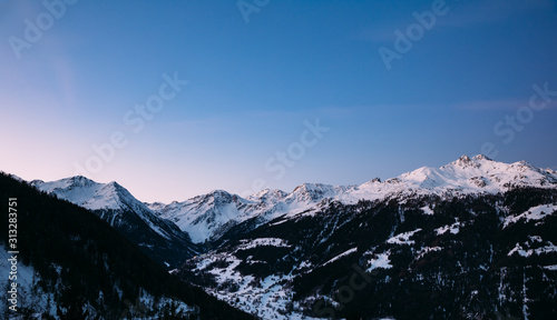 Morning sky over snowy mountains at sunrise in the Swiss Alps.
