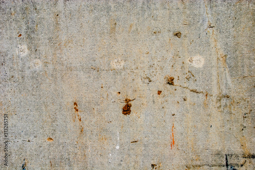 Smooth concrete wall with dirt.