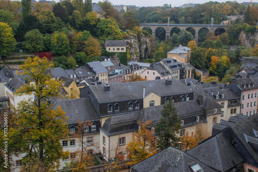 view of the fortified city, the capital of the Grand Duchy of Luxembourg, is the richest state in Europe. Old medieval city with fortified walls, a cathedral and houses in the fall.