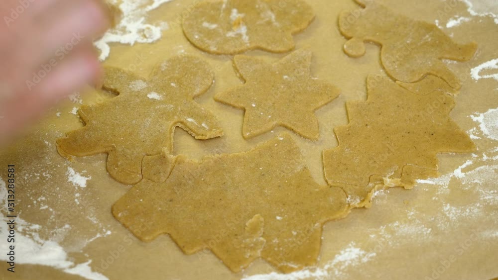 Close-up shot of female hands cutting out gingerbread cookies. 4K Close-up shot of female hands cutting out gingerbread cookies. 4K