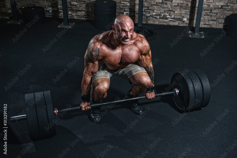 Bodybuilder doing heavy dead lift in the gym Bodybuilder doing heavy dead lift in the gym