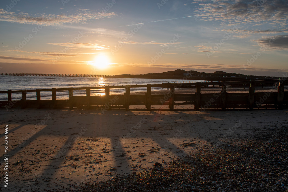 Beautiful Sunset Littlehampton Seafront, Sun casting long shadows on the sandy beach as it slip towards the horizon. Beautiful Sunset Littlehampton Seafront, Sun casting long shadows on the sandy beach as it slip towards the horizon.