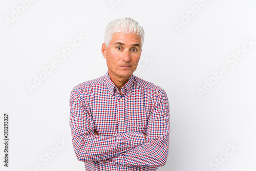Senior caucasian man isolated frowning face in displeasure  keeps arms folded.