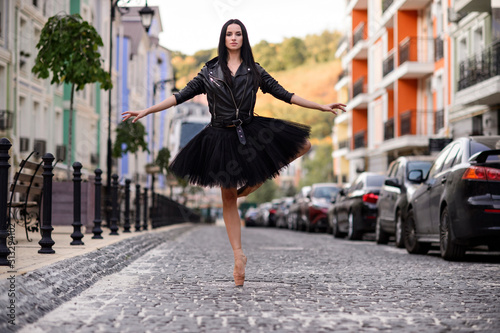 Elegant ballet dancer young girl dancing ballet outdoors.