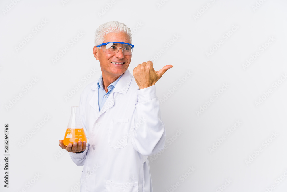 Mature chemical man isolated points with thumb finger away, laughing and carefree. Mature chemical man isolated points with thumb finger away, laughing and carefree.