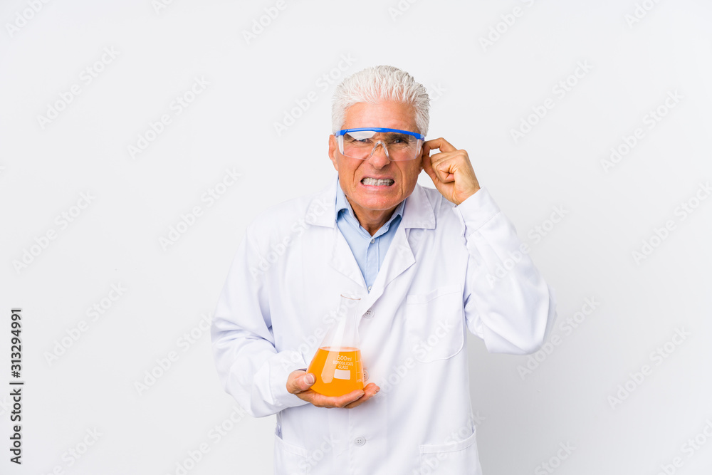 Mature chemical man isolated covering ears with hands. Mature chemical man isolated covering ears with hands.
