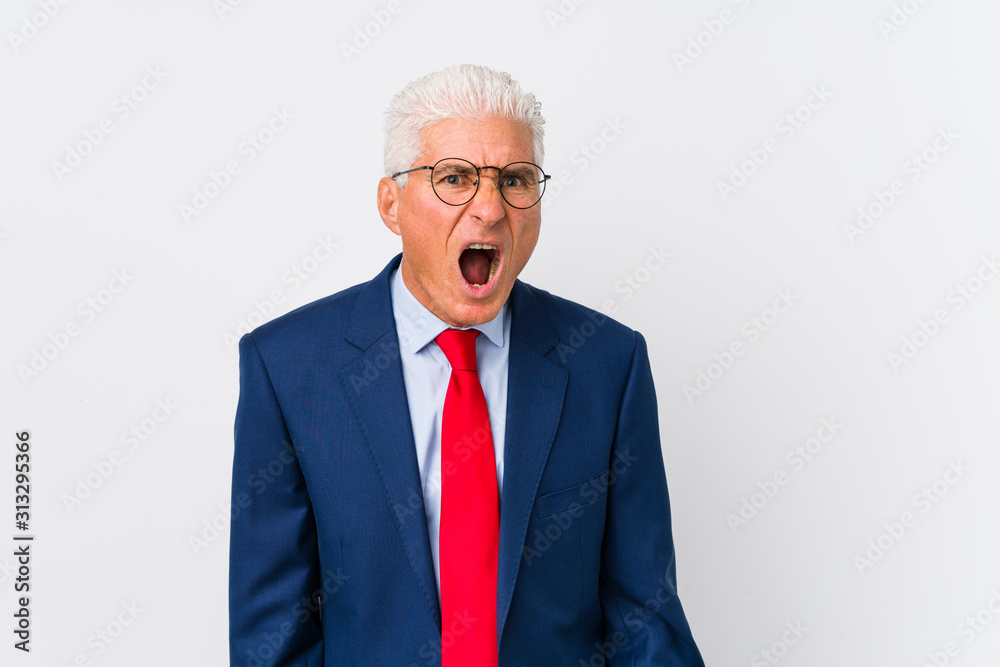 Middle aged caucasian business man isolated screaming very angry and aggressive.