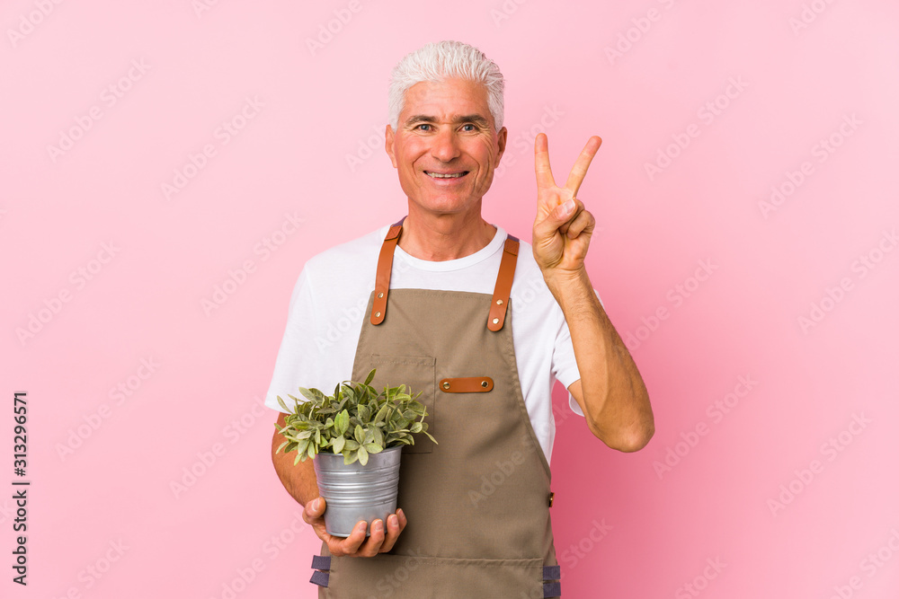 Middle aged gardener man isolated showing number two with fingers. Middle aged gardener man isolated showing number two with fingers.