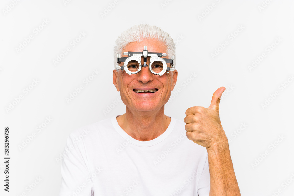 Senior caucasian man wearing a optometrist trial frame smiling and raising thumb up