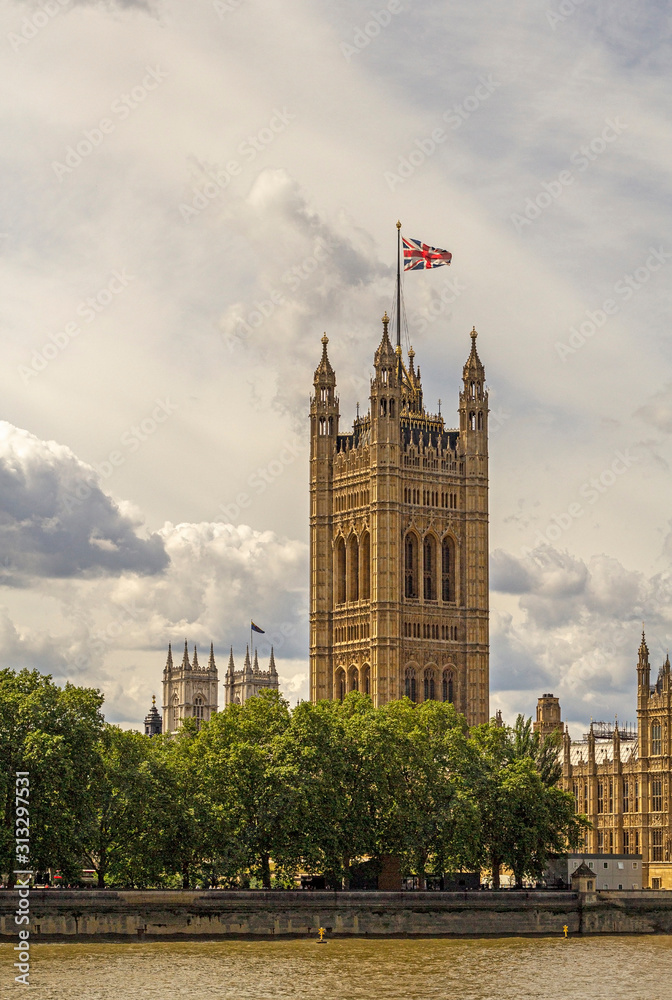 Fototapeta premium looking across the river thames at the victoria tower which is part of the palace of westminster