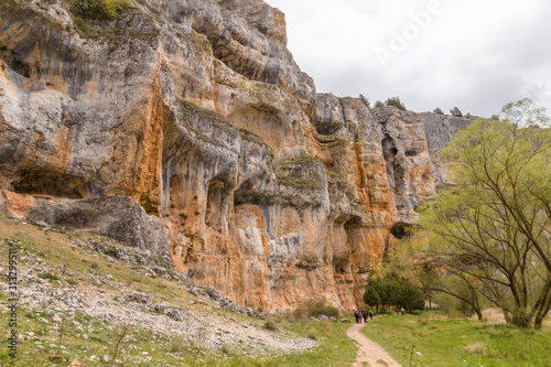 Hikers close to a limestone cliff