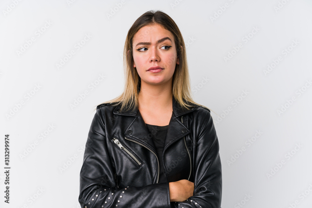 Young caucasian woman wearing a black leather jacket confused, feels doubtful and unsure. Young caucasian woman wearing a black leather jacket confused, feels doubtful and unsure.