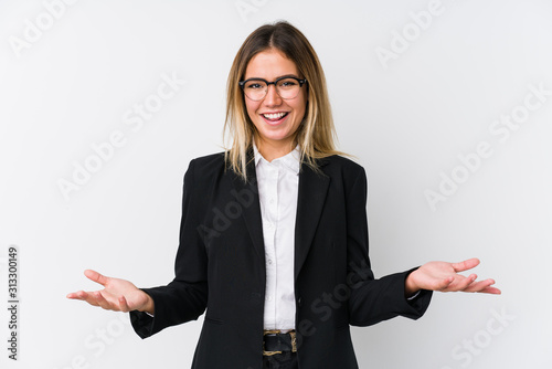 Young business caucasian woman showing a welcome expression.