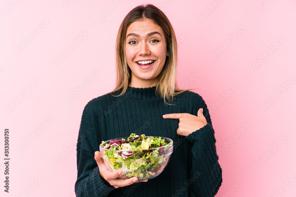 Young caucasian woman holding a salad isolated surprised pointing at himself, smiling broadly. Young caucasian woman holding a salad isolated surprised pointing at himself, smiling broadly.