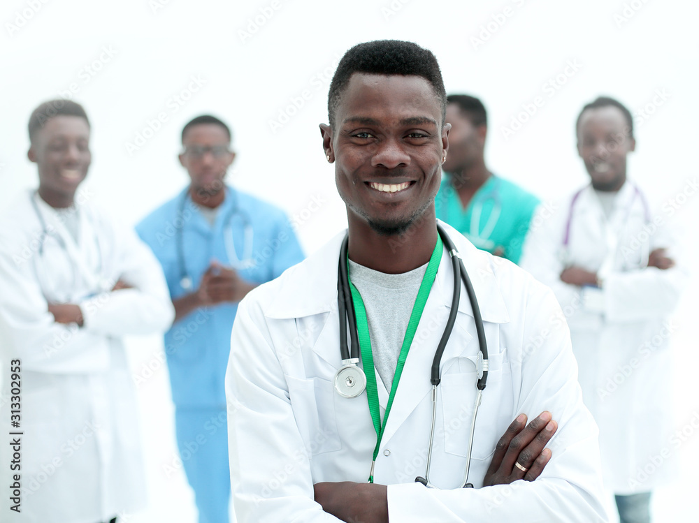 young confident doctor on the background of his colleagues young confident doctor on the background of his colleagues