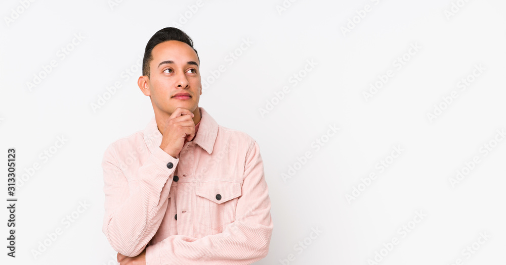 Young latin man posing isolated looking sideways with doubtful and skeptical expression. Young latin man posing isolated looking sideways with doubtful and skeptical expression.