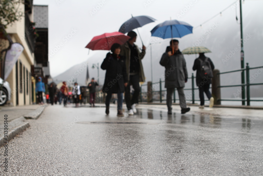 MIRRORED STREET IN RAIN. CITYSPACE IN HALLSTATT, AUSTRIA MIRRORED STREET IN RAIN. CITYSPACE IN HALLSTATT, AUSTRIA