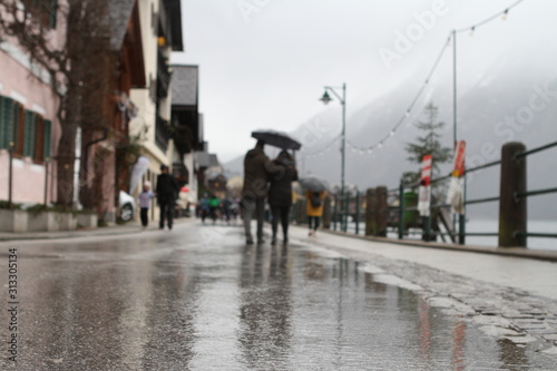 MIRRORED STREET IN RAIN. CITYSPACE IN HALLSTATT, AUSTRIA