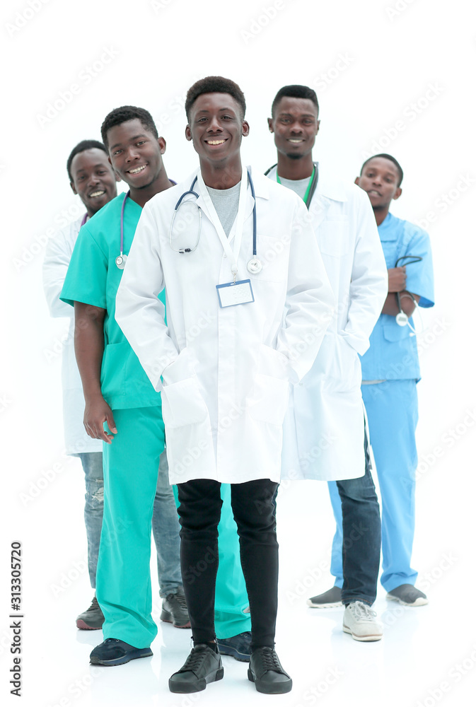 in full growth. smiling young doctors standing one by one in full growth. smiling young doctors standing one by one