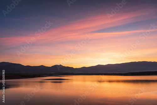 Beautiful color sunset landscape with swamp lake  with reflections of calm blurred water