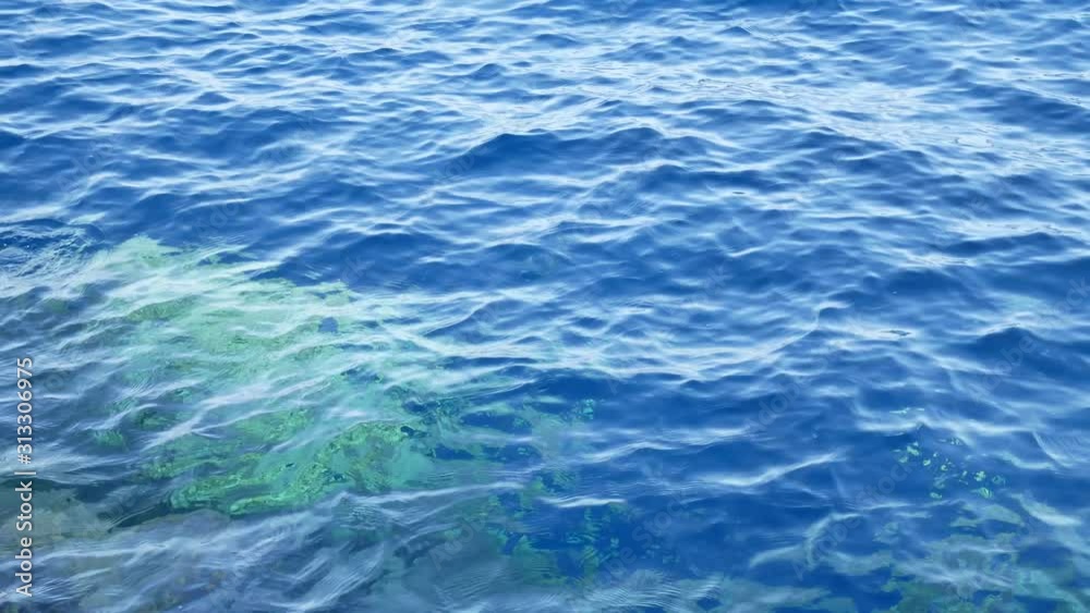 Blue sea water with white foam for background. Nature background concept. Wave surface Blue sea water with white foam for background. Nature background concept. Wave surface