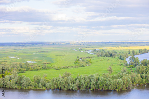 greenfield landscape scene with river and cloudy sky