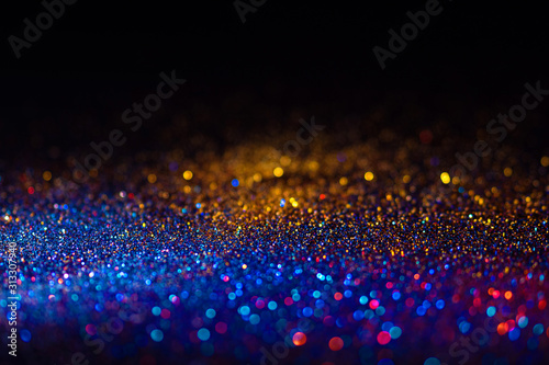 Multicolored shining glitter in focus and out of focus, abstract shiny background