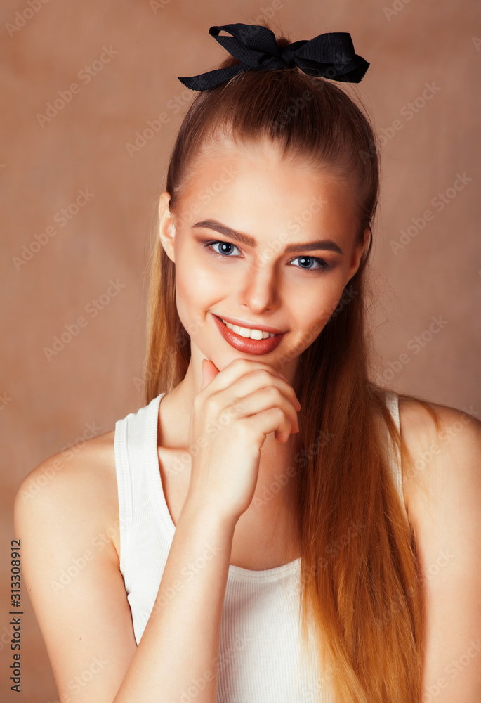 young pretty blond woman with fresh natural makeup posing cheerful on browm background, lifestyle people concept young pretty blond woman with fresh natural makeup posing cheerful on browm background, lifestyle people concept