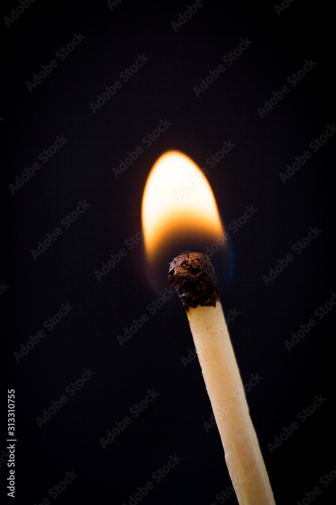 Lighting matches at the moment when it explodes. Burning match over black background. Close up. Copy space. Lighting matches at the moment when it explodes. Burning match over black background. Close up. Copy space.