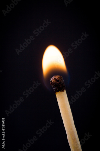Lighting matches at the moment when it explodes. Burning match over black background. Close up. Copy space.