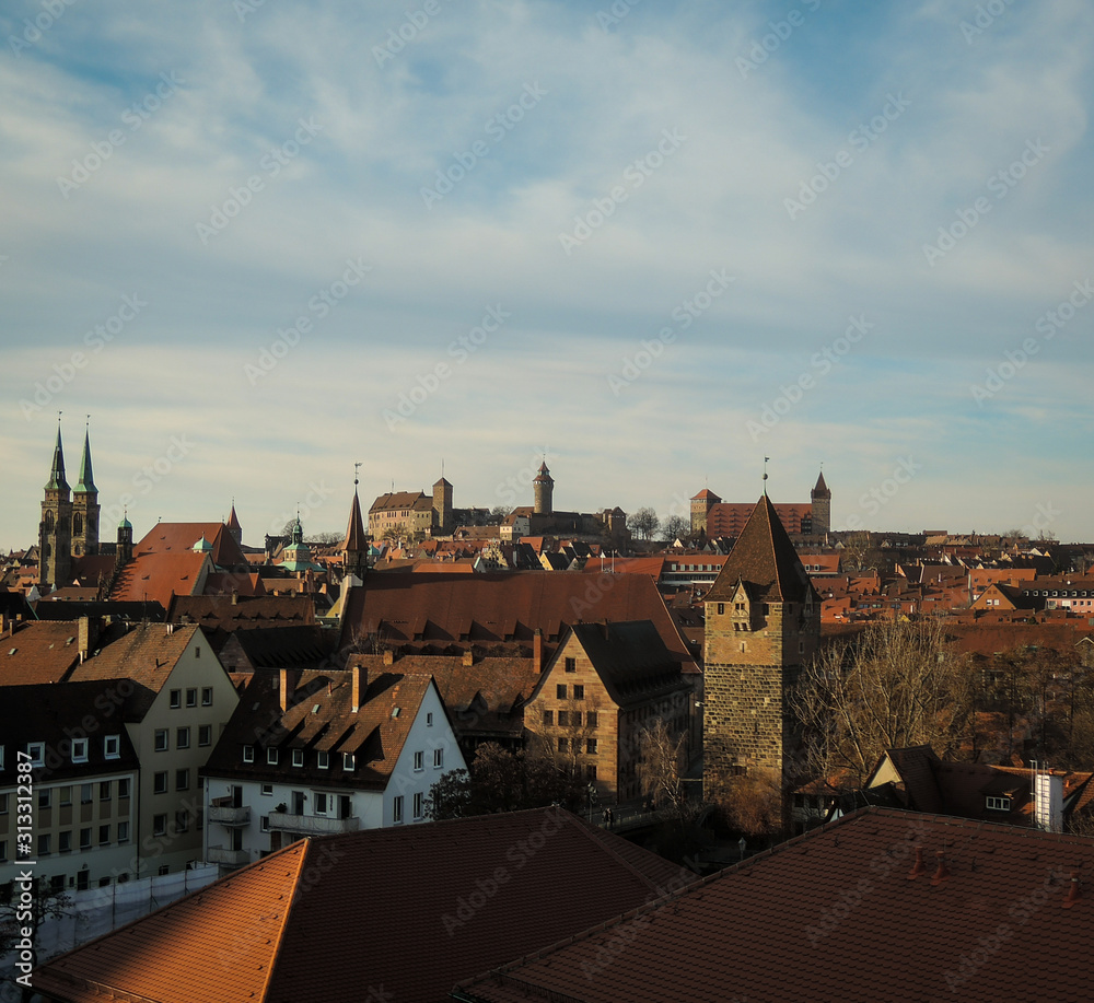 Aerial view of Nuremberg city with rooftops and medieval old castle towers and churches.