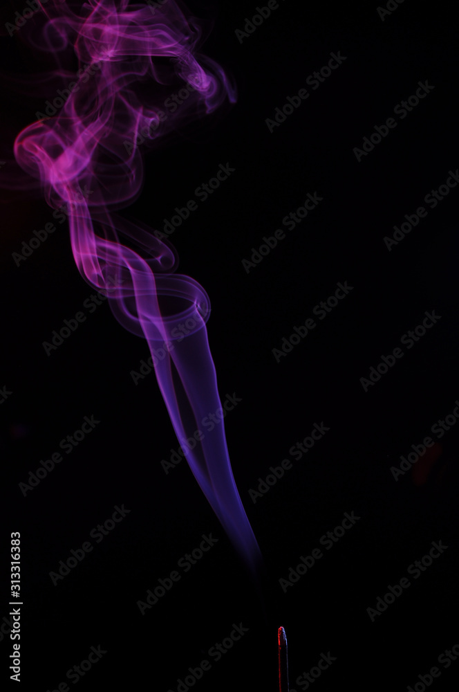 lilac smoke incense sticks on a black background. abstract figures of blue smoke on a black background lilac smoke incense sticks on a black background. abstract figures of blue smoke on a black background